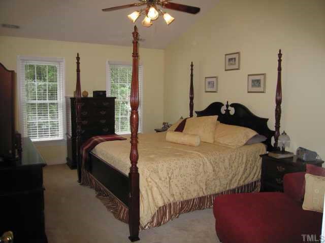 5616 Raddington Street Raleigh, NC 27613 - Photo 6 of 10 a bedroom with bed and window
