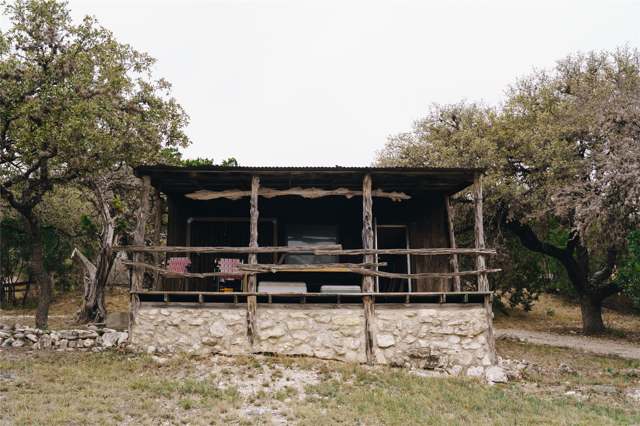 1850 Ranch Road 337 Leakey, TX 78873 - Photo 21 of 31 a backyard of a house with barbeque oven and trees