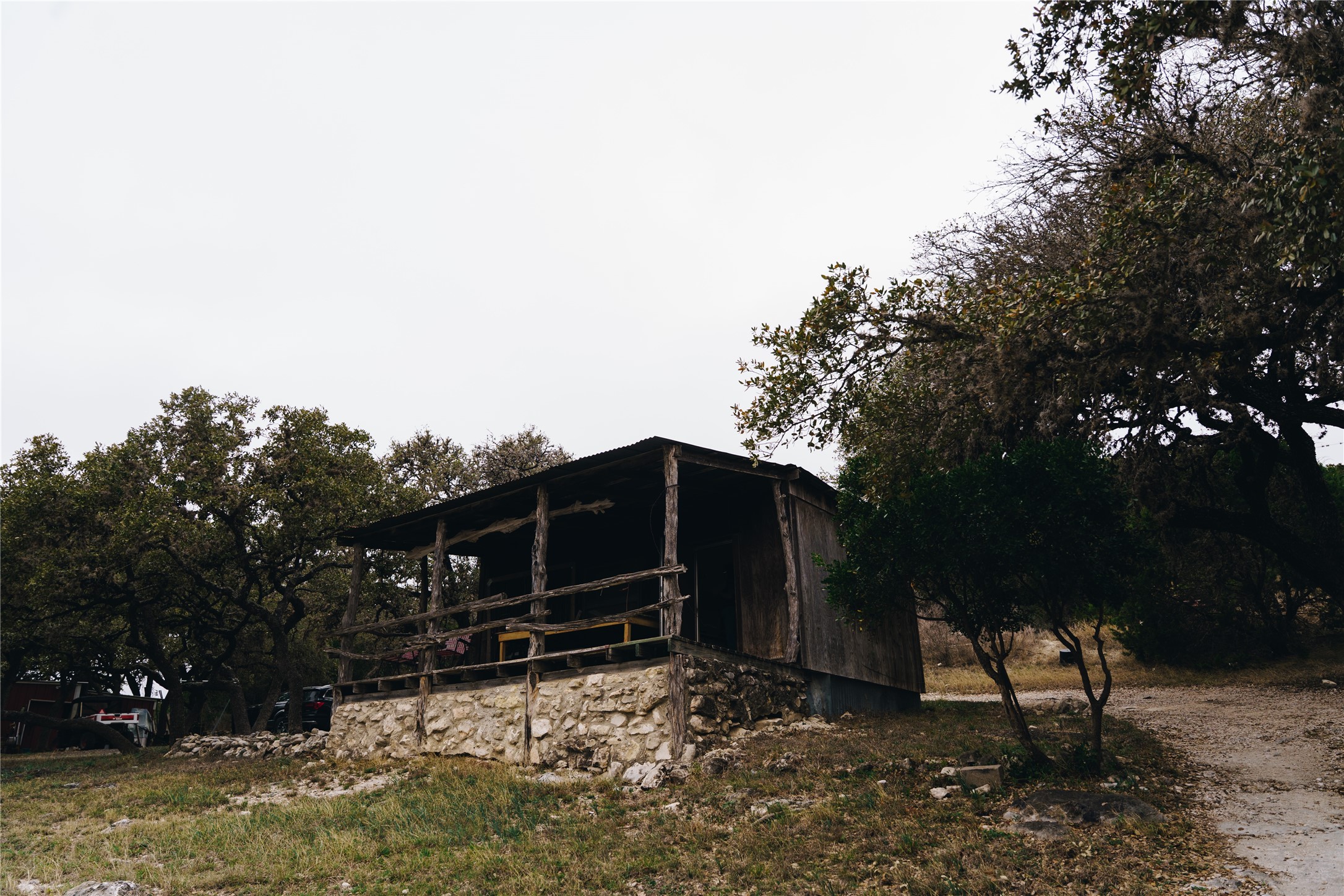 1850 Ranch Road 337 Leakey, TX 78873 - Photo 24 of 31 a backyard of a house with wooden fence and trees