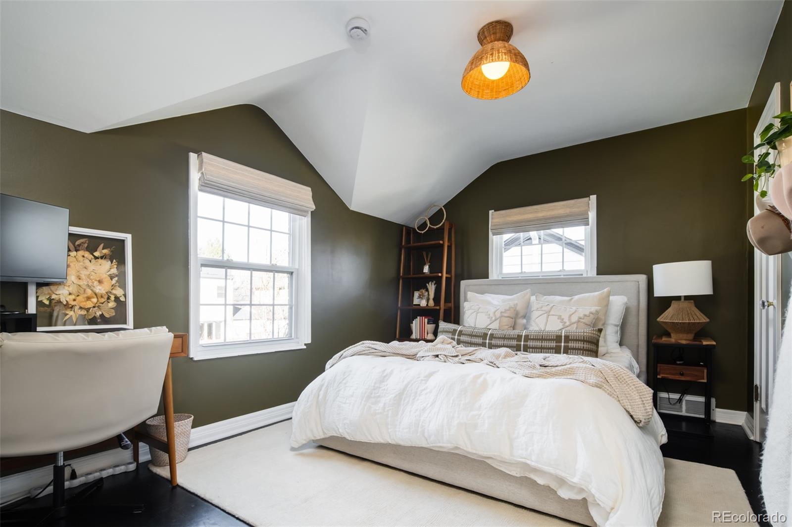 457 Elm Street Denver, CO 80220 - Photo 22 of 45 a bedroom with a bed and a lamp next to a window