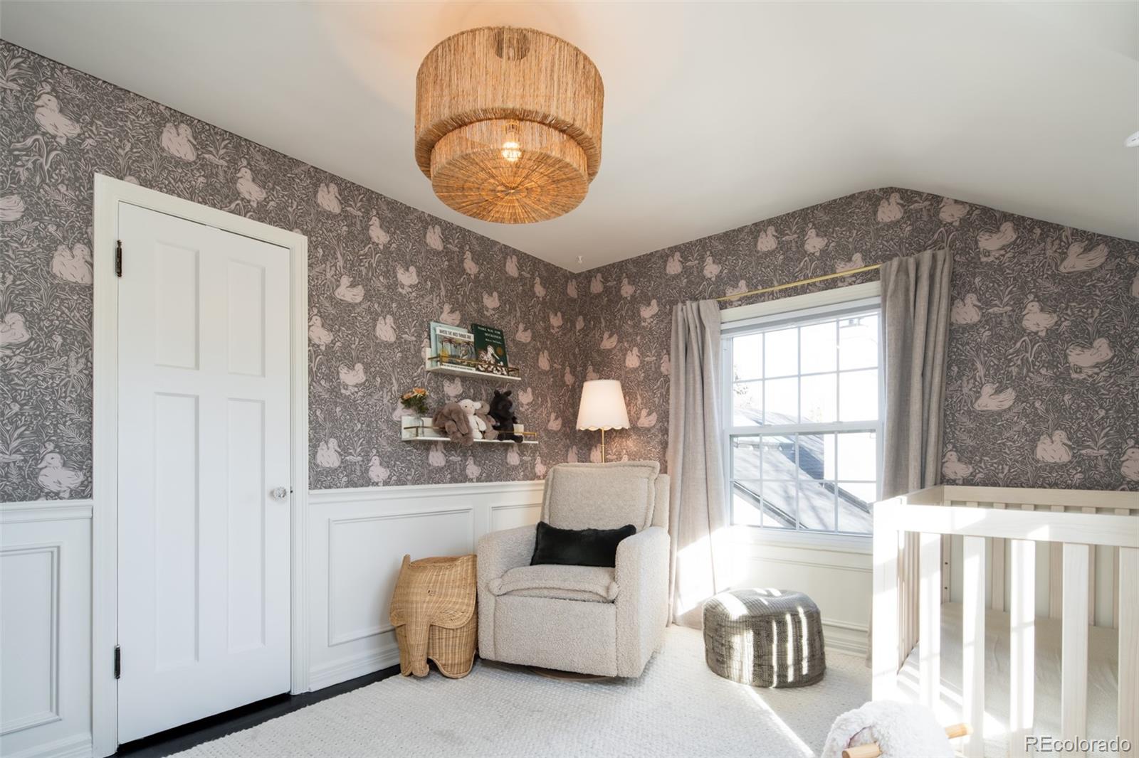 457 Elm Street Denver, CO 80220 - Photo 24 of 45 a living room with furniture and a chandelier