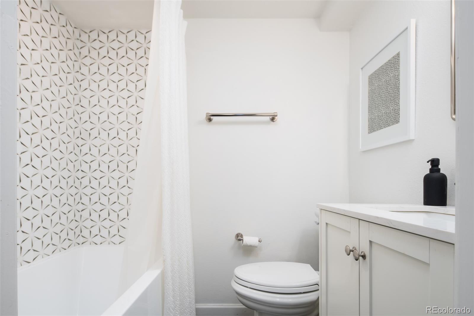 457 Elm Street Denver, CO 80220 - Photo 30 of 45 a bathroom with a sink a toilet and shower