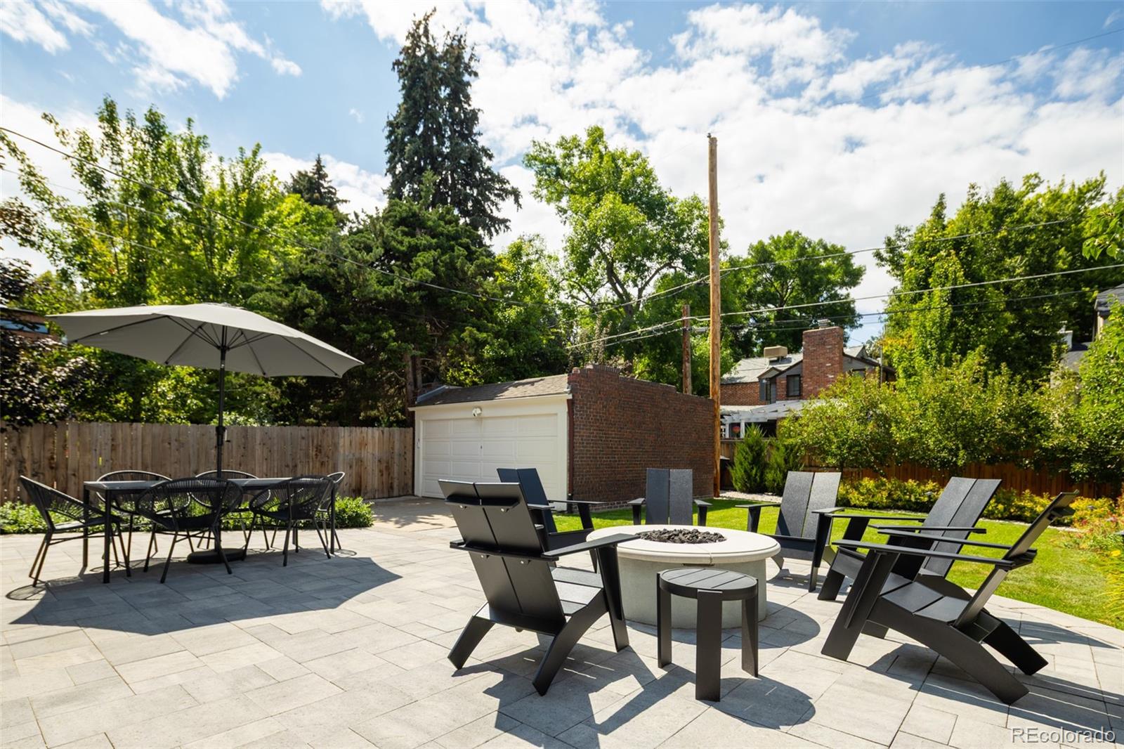 457 Elm Street Denver, CO 80220 - Photo 36 of 45 a view of a tables and chairs under an umbrella