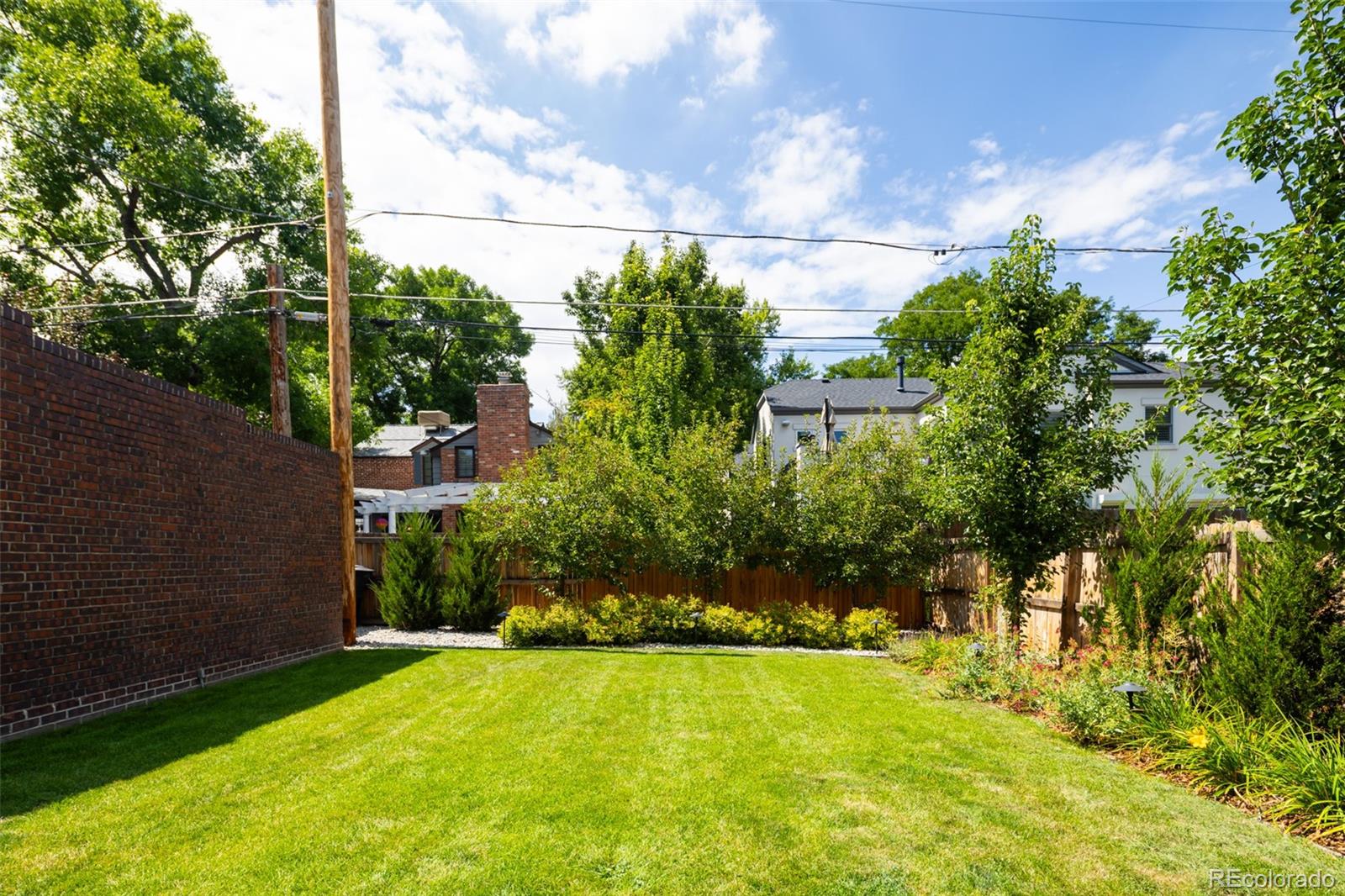 457 Elm Street Denver, CO 80220 - Photo 37 of 45 a view of yard with swimming pool and green space