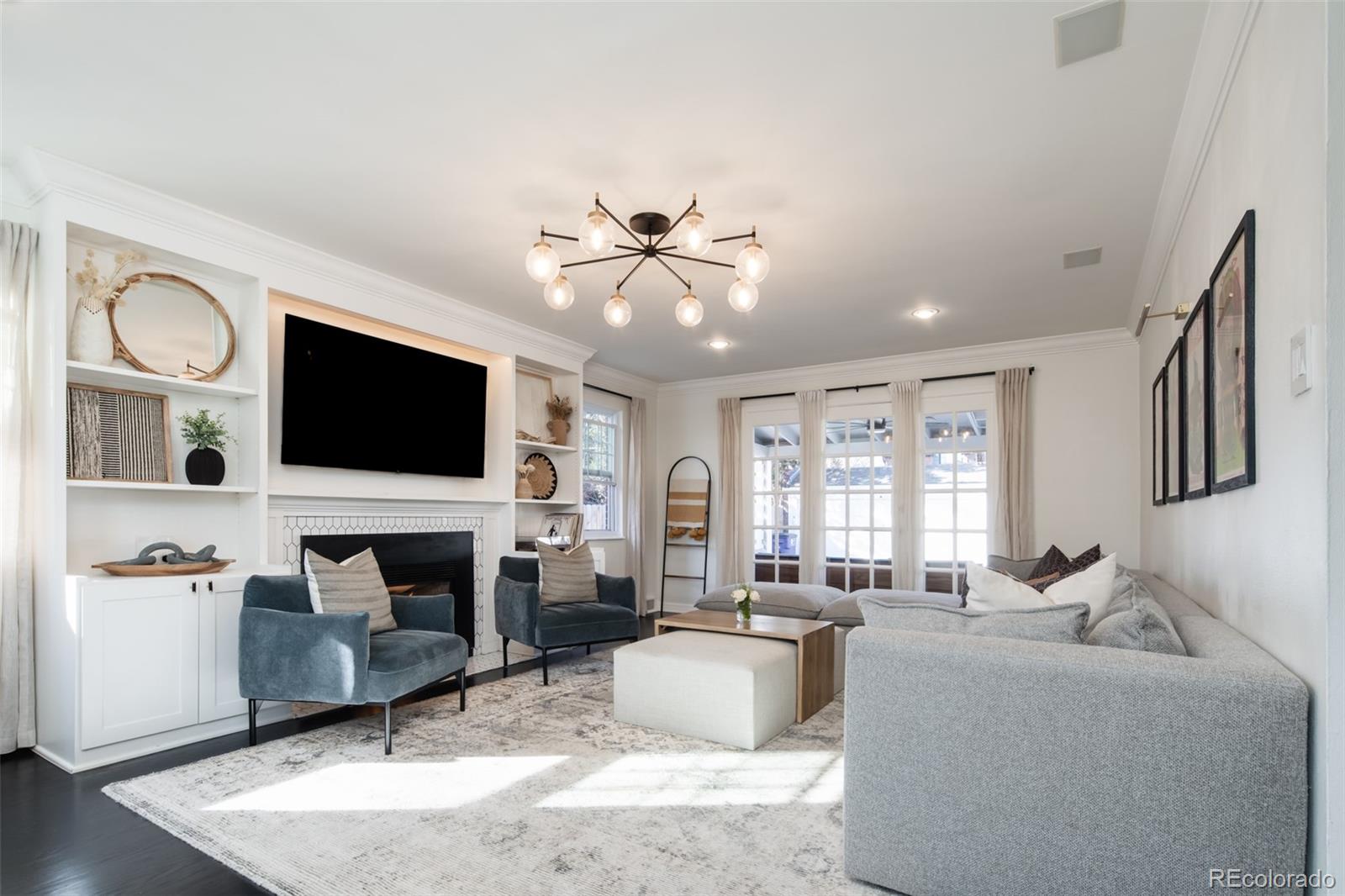 457 Elm Street Denver, CO 80220 - Photo 7 of 45 a living room with fireplace furniture and a flat screen tv