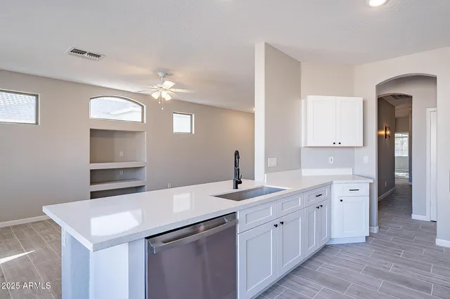 a spacious bathroom with double vanity and a mirror