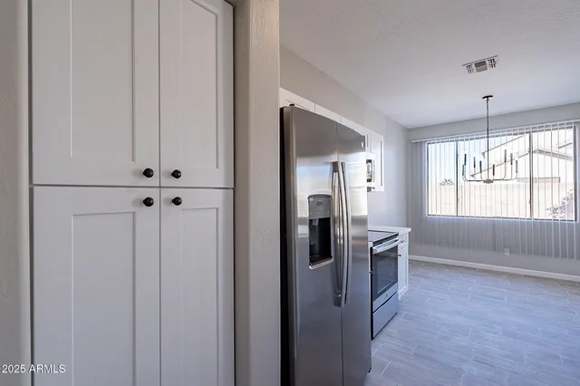 a view of a room with wooden floor and windows