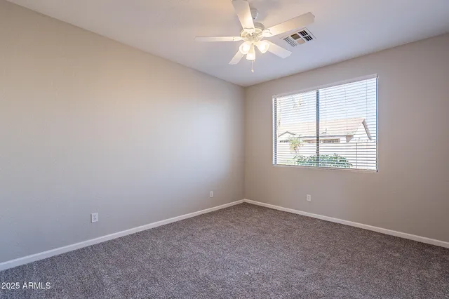 a view of an empty room and closet area