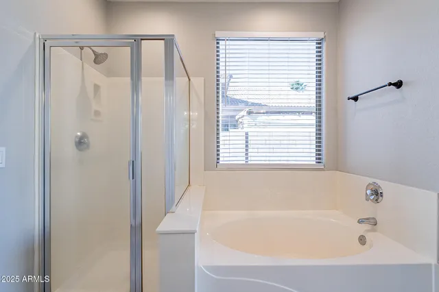 a bathroom with a bathtub a mirror a sink and vanity