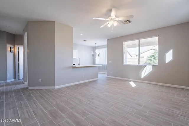 a view of kitchen with sink and refrigerator