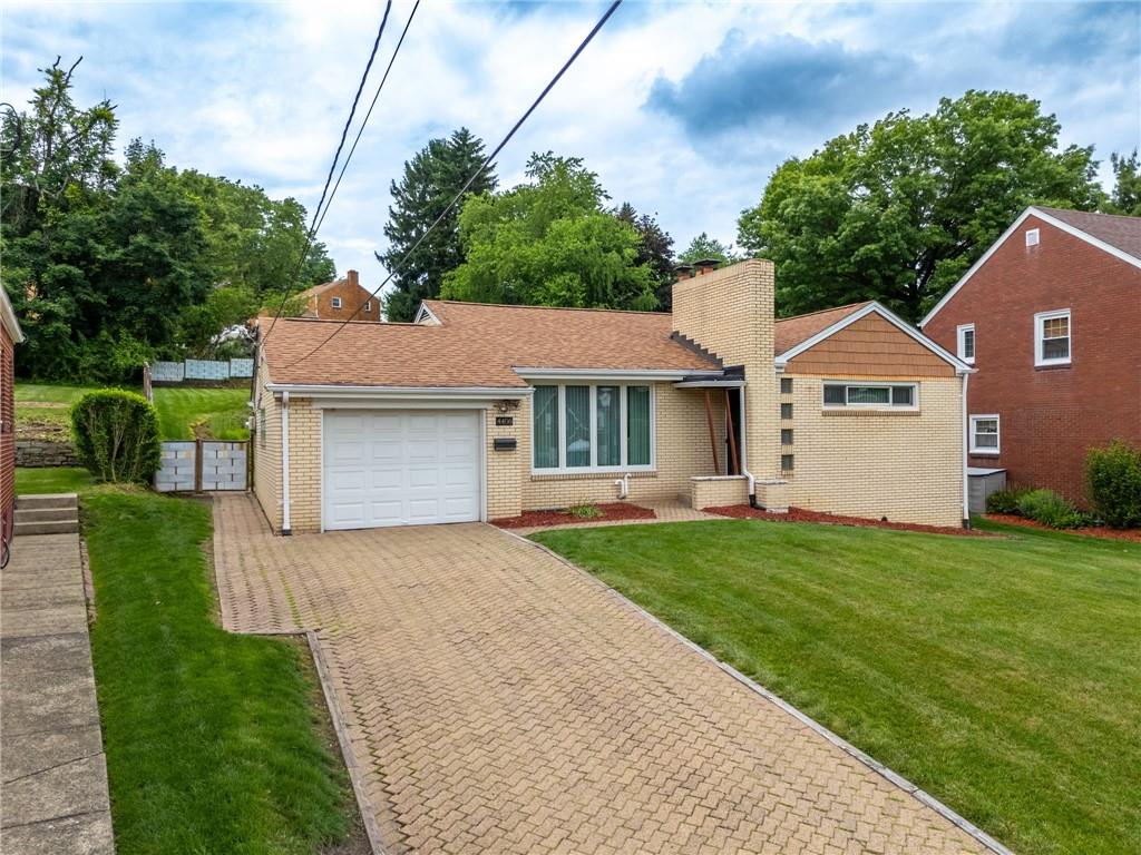 Welcome home to 4406 West Run Rd, with the long brick paver driveway.