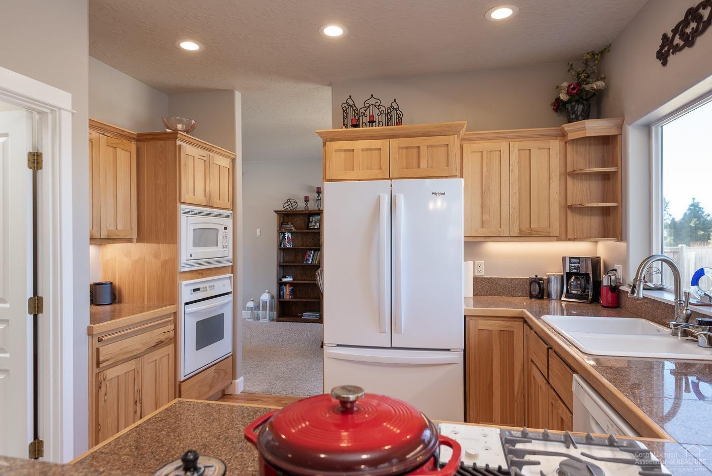 3341 Northeast Stonebrook Loop Bend, OR 97701 - Photo 8 of 25 a kitchen with stainless steel appliances a refrigerator sink and cabinets