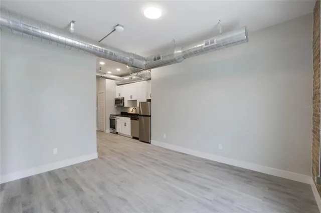 an empty room with wooden floor