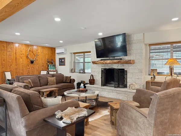 a living room with furniture and a air conditioner vent
