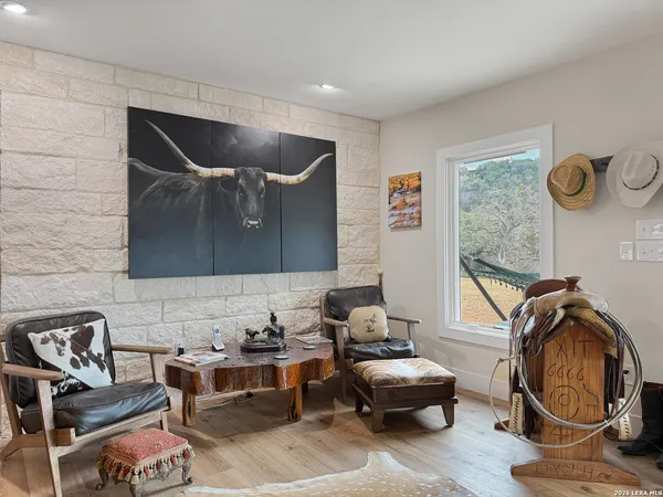 a large bedroom with a bed and a ceiling fan