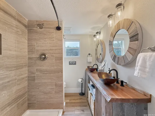 a bathroom with a sink a toilet and a shower curtain