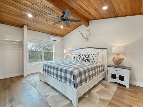 a bedroom with bed and window