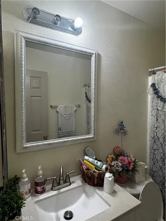 a bathroom with a sink mirror and vanity