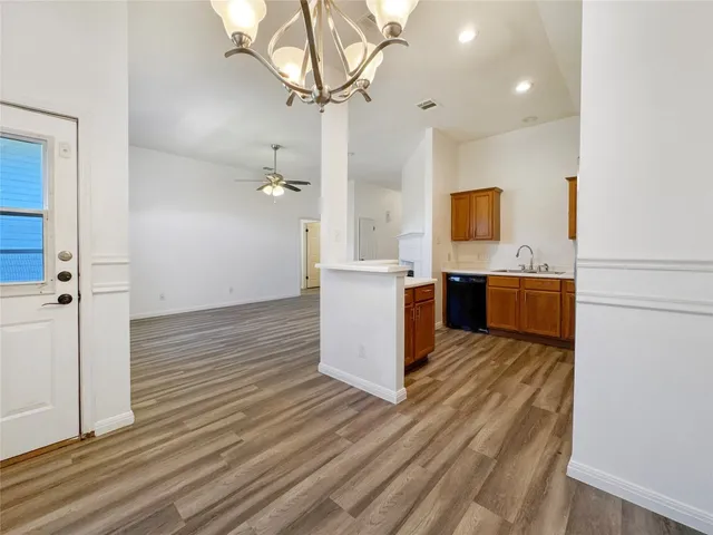 a kitchen with a stove and wooden floor