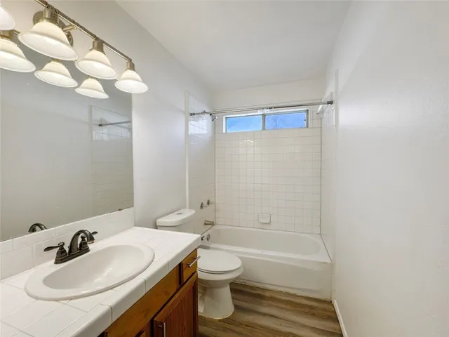 a view of a room with a ceiling fan and a window
