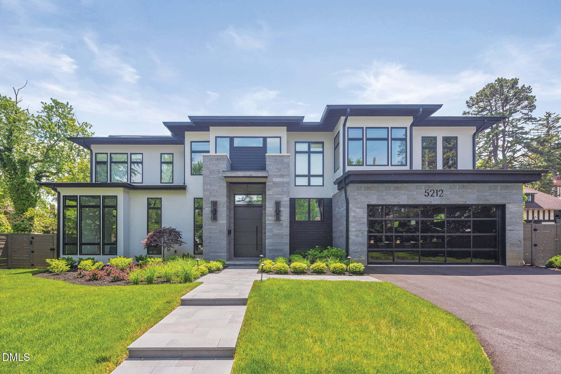 a front view of a house with a garden and yard