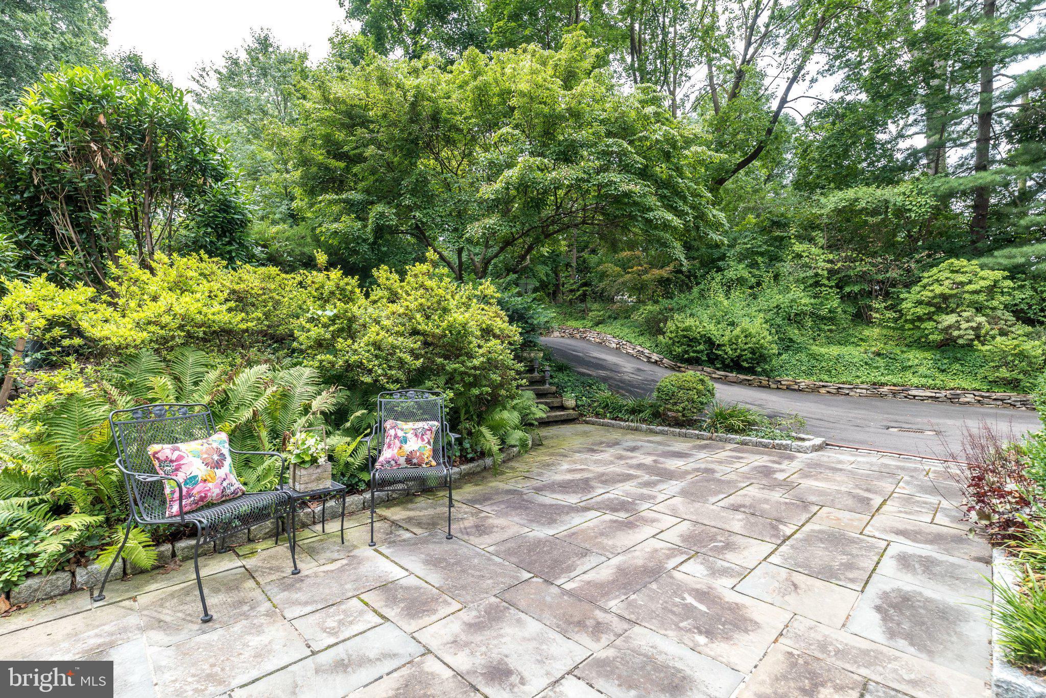 24 Springtree Lane Yardley, PA 19067 - Photo 5 of 84 a backyard with table and chairs and potted plants