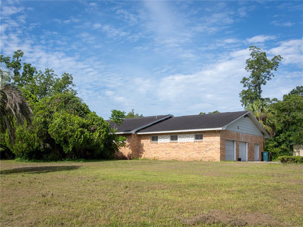 530 Southwest 23rd Avenue Ocala, FL 34471 - Photo 17 of 26 a front view of house with yard and trees in the background
