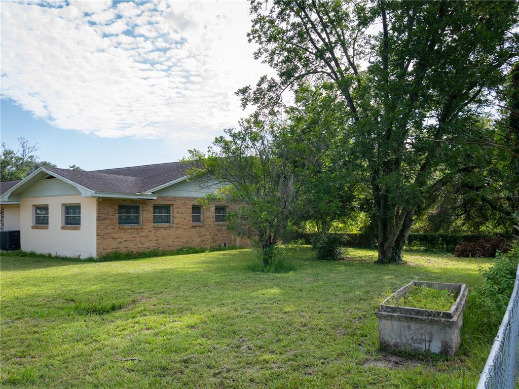 530 Southwest 23rd Avenue Ocala, FL 34471 - Photo 18 of 26 a view of a house with a big yard plants and large trees