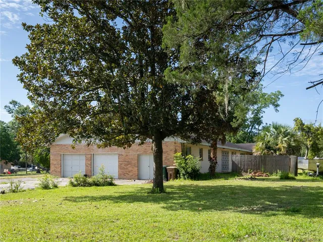 a front view of house with yard and trees