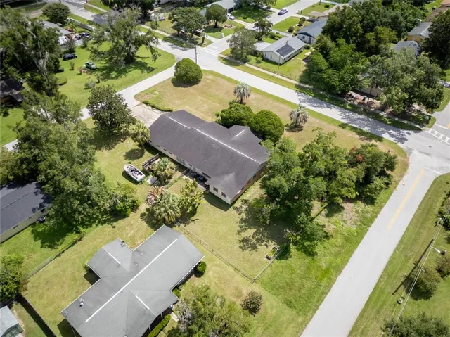 an aerial view of a house with a yard