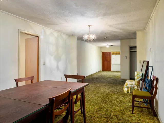 a view of a dining room with furniture and a chandelier