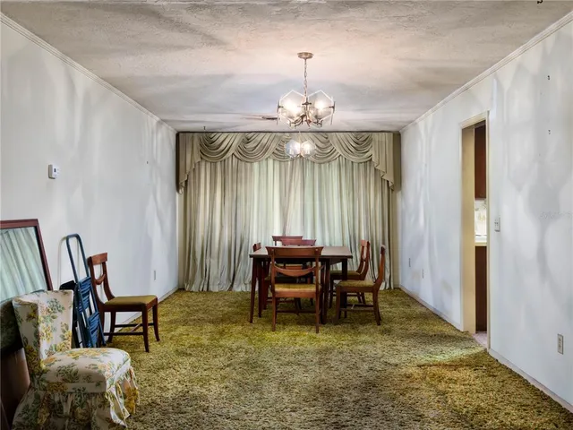 a view of a dining room with furniture and chandelier