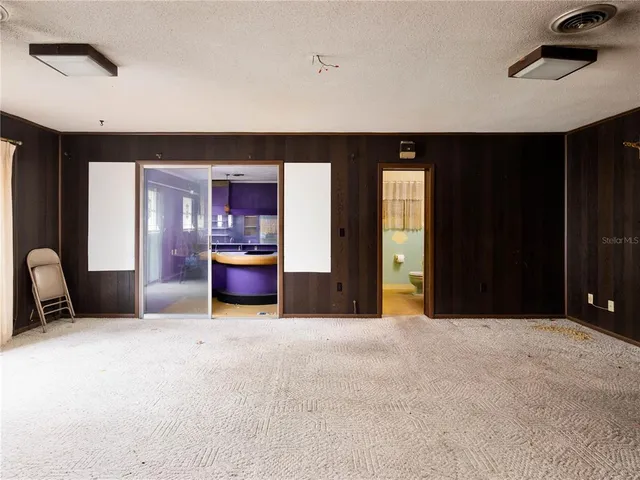 a living room with a large bed and furniture