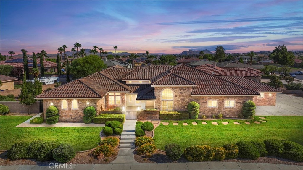 19188 Elkhorn Road Apple Valley, CA 92308 - Photo 1 of 1 a front view of a house with garden