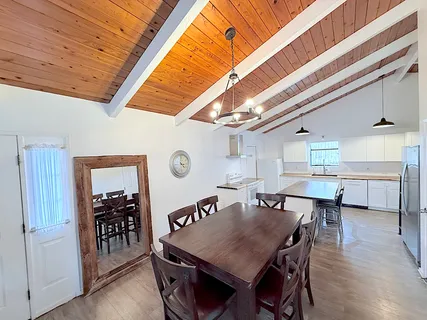 a dining room with a wooden table and chairs