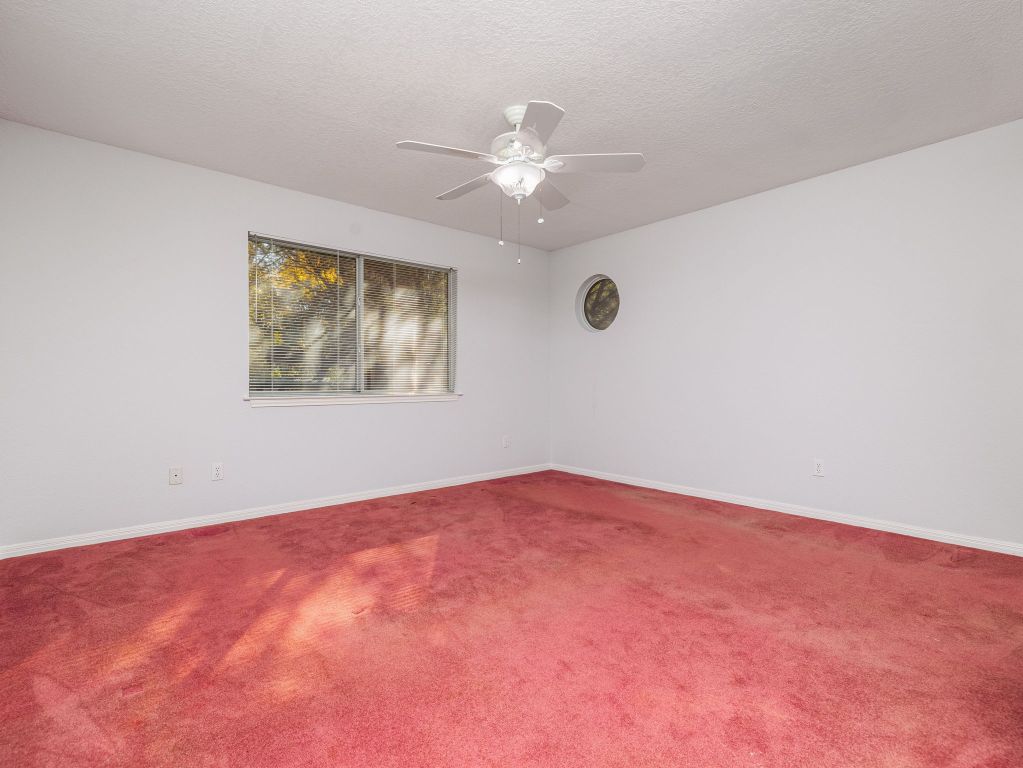 3707 Wyldwood Road Austin, TX 78739 - Photo 12 of 30 an empty room with windows and fan