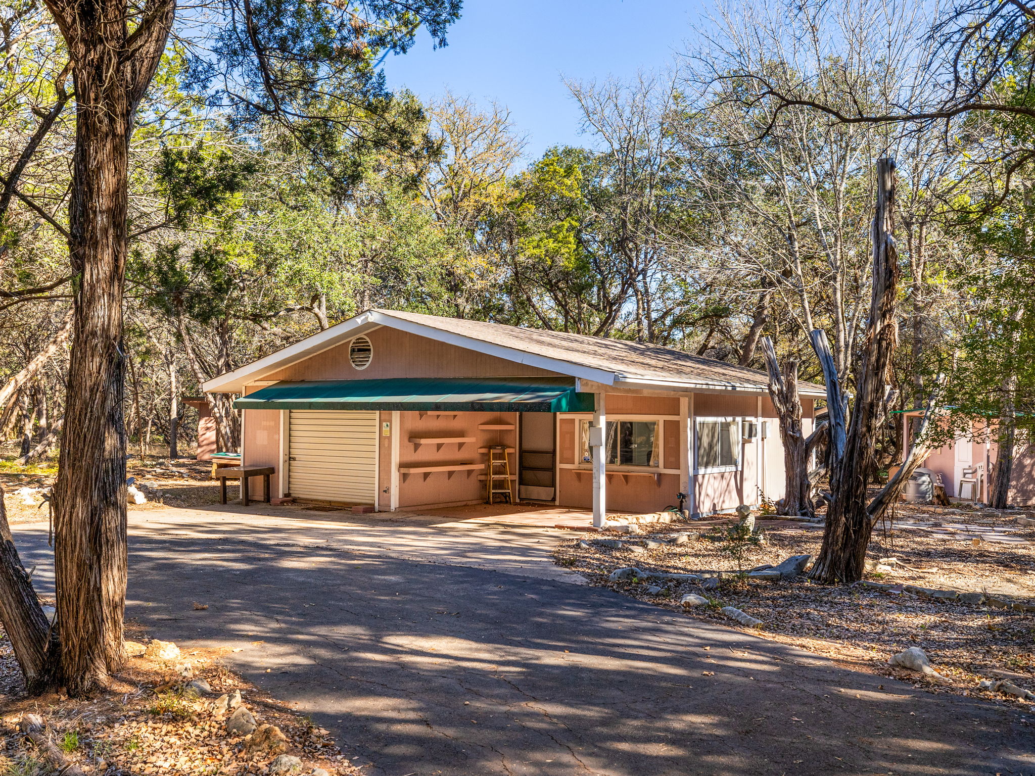 3707 Wyldwood Road Austin, TX 78739 - Photo 15 of 30 a front view of a house with a garden and trees