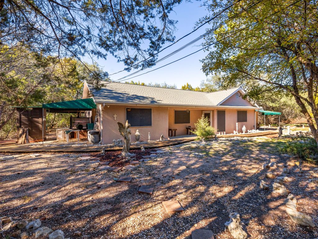 3707 Wyldwood Road Austin, TX 78739 - Photo 19 of 30 a view of a house with backyard sitting area and porch