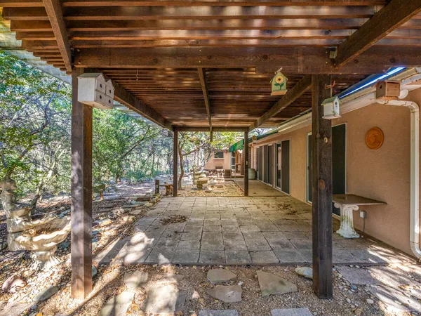 a backyard of a house with a large tree