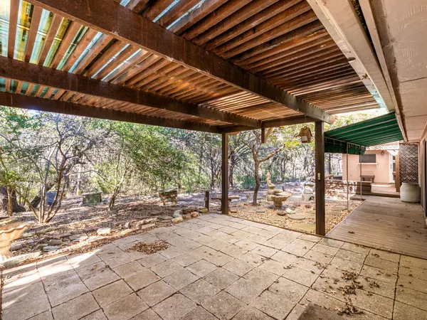 a view of a house with backyard and sitting area