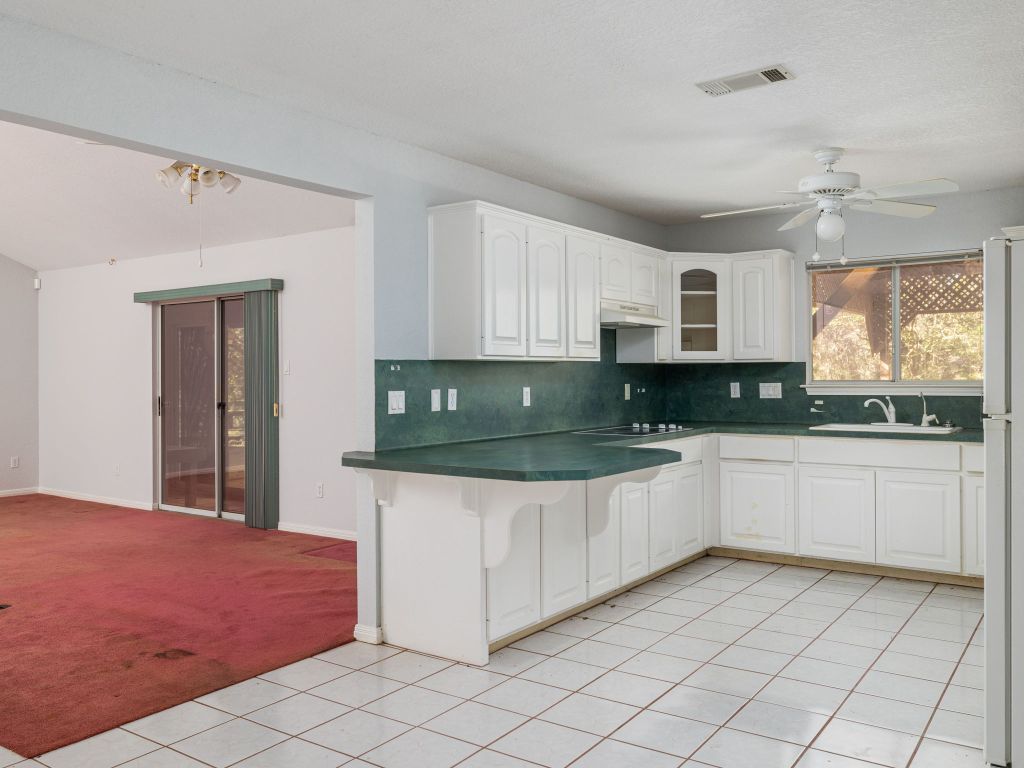 3707 Wyldwood Road Austin, TX 78739 - Photo 30 of 30 a kitchen with granite countertop white cabinets and window