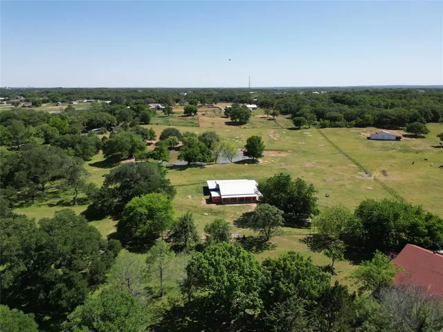 an aerial view of lake and residential houses with outdoor space