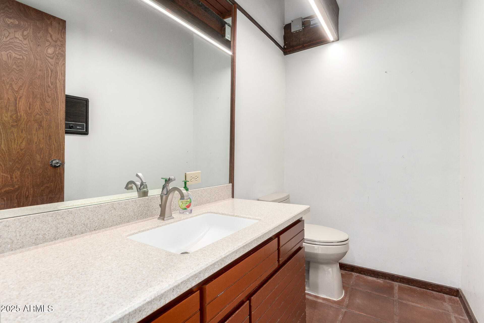 5275 North Camelhead Road Phoenix, AZ 85251 - Photo 54 of 72 a bathroom with a granite countertop sink and a mirror