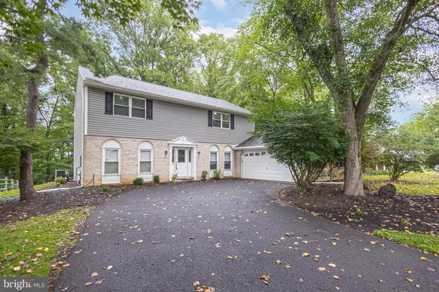 a view of a house with a tree in front of it