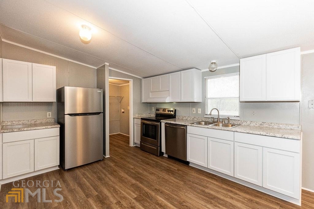 108 Sherwood Road Rincon, GA 31326 - Photo 16 of 28 a kitchen with a sink a refrigerator and white cabinets