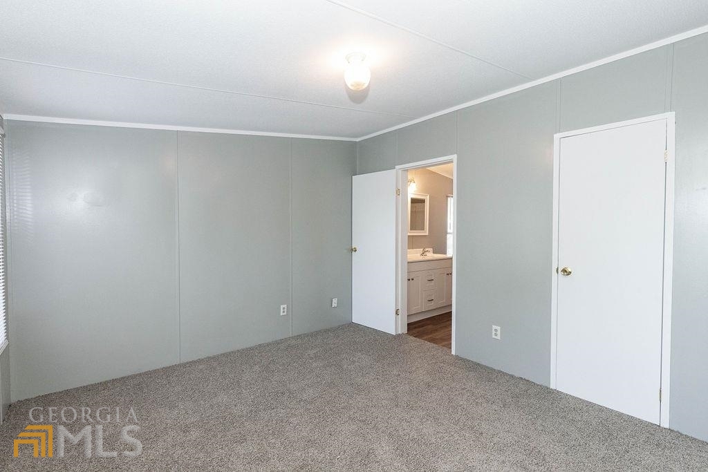 108 Sherwood Road Rincon, GA 31326 - Photo 23 of 28 an empty room with closet and mirror