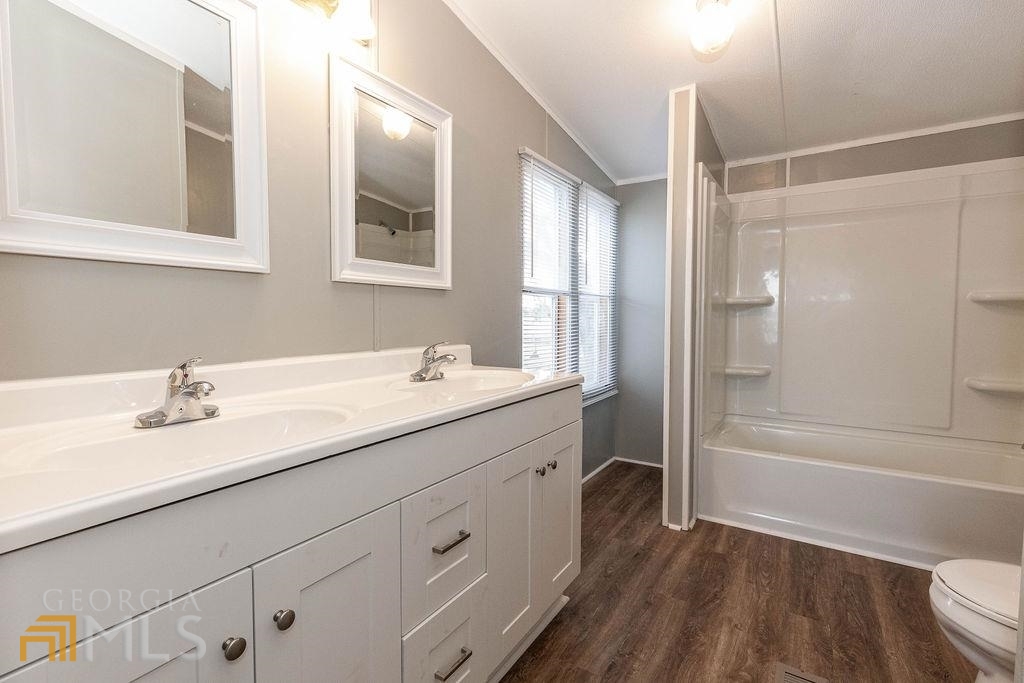 108 Sherwood Road Rincon, GA 31326 - Photo 25 of 28 a bathroom with a granite countertop sink mirror toilet and bathtub