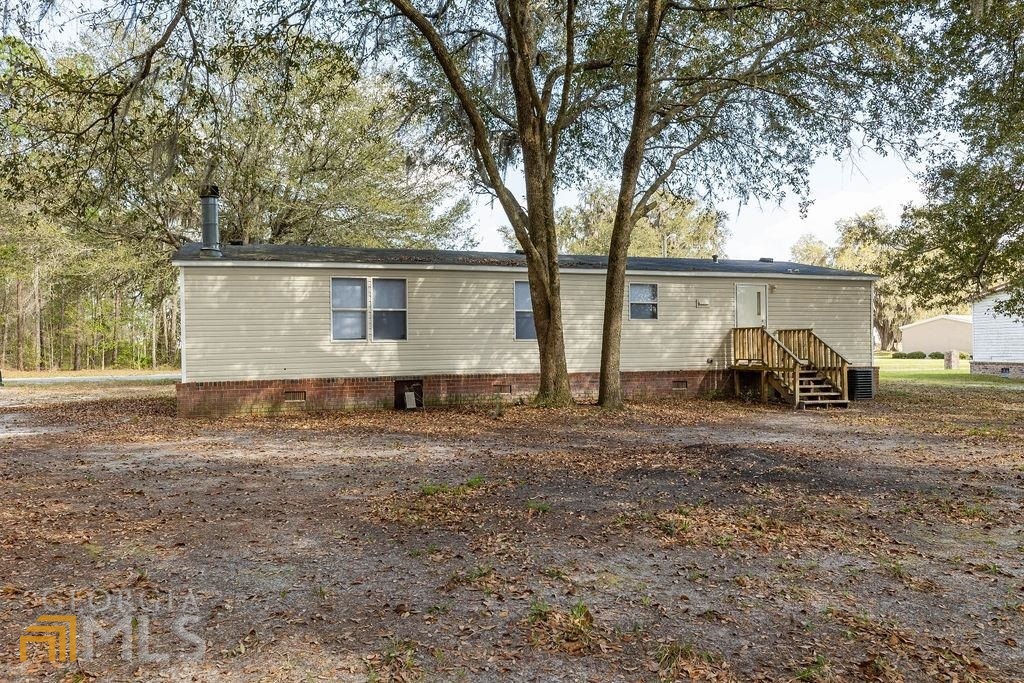 108 Sherwood Road Rincon, GA 31326 - Photo 8 of 28 a small white house with a outdoor space