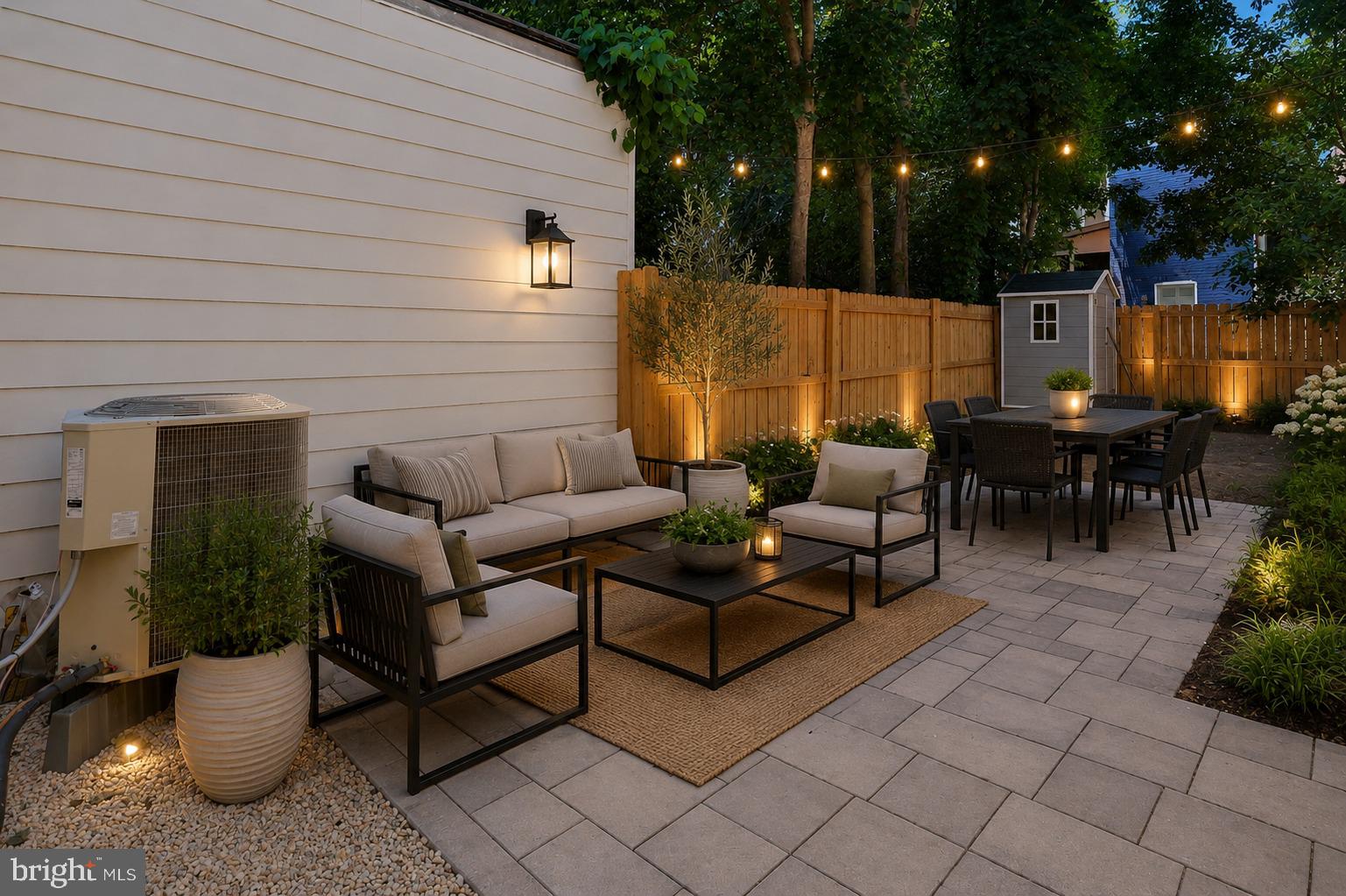 513 Manor Street Lancaster, PA 17603 - Photo 35 of 37 a view of a patio with couches and table and chairs with wooden fence and plants