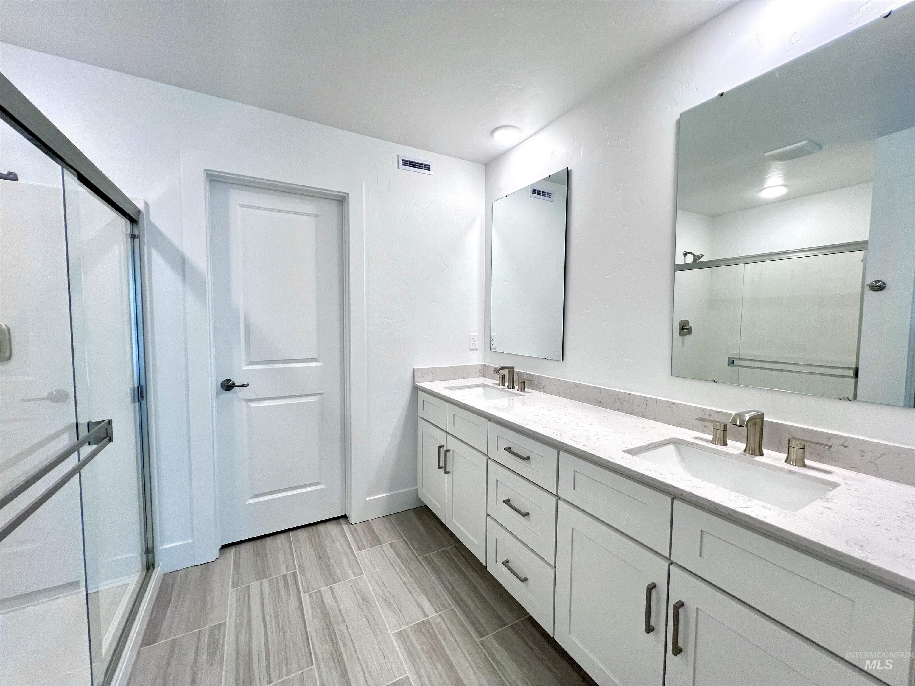 8098 West Fern Street Eagle, ID 83616 - Photo 16 of 22 Dual vanity with quartz countertops, undermount sinks, and brushed nickel fixtures